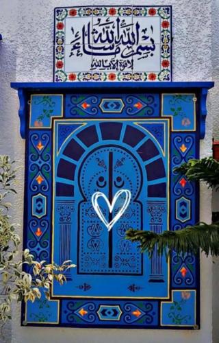 a painting of a blue door with a heart at Dar El Kasba Riad Guest House in Bizerte