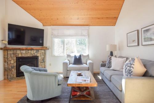a living room with a couch and a fireplace at 3000 Sq Ft Home with Hot Tub in Eastham