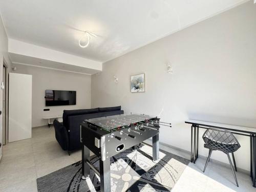 a living room with a ping pong table and a couch at Casa Neghelli - Alassio in Alassio