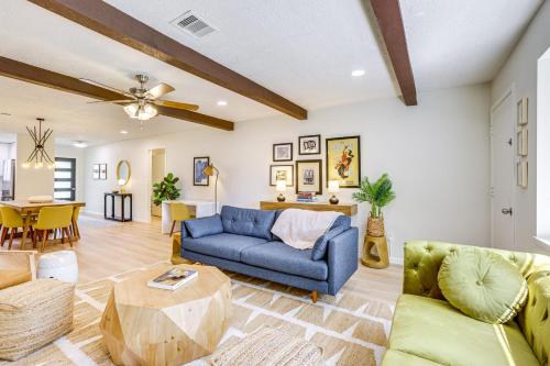 a living room with a blue couch and a table at 5 Mi to Lake Houston Family Home in Humble in Humble