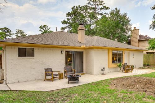 a white house with a patio and a table at 5 Mi to Lake Houston Family Home in Humble in Humble