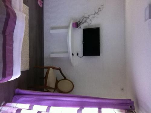 a bedroom with a bed with a tennis racket on it at Sunny House in Skopje