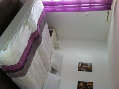 a bedroom with a bed with a purple ceiling at Sunny House in Skopje
