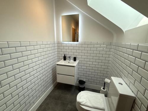 a white bathroom with a toilet and a sink at Luxury 1 bed - 7 Queen Street Abingdon - Centrally located parking subject to availability in Abingdon