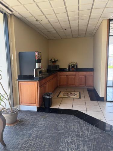 a large kitchen with wooden cabinets and a tile floor at Emerald Inn in Maplewood