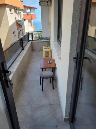 a small table and a chair on a balcony at Mukka Apart Hotel - شقق موكا الفندقية in Trabzon
