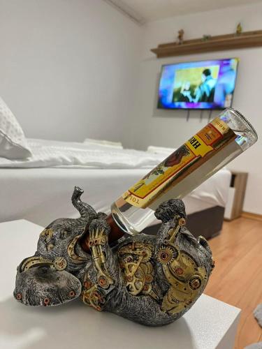 a statue of a snake holding a bottle and a remote control at Stanojkov 2 in Bovec