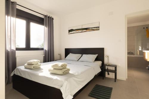 a bedroom with a bed with towels on it at Holiday house Nova in Ližnjan