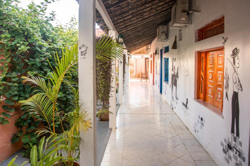 an empty corridor of a building with plants at Vila Aju - Pousada Temática in Aracaju