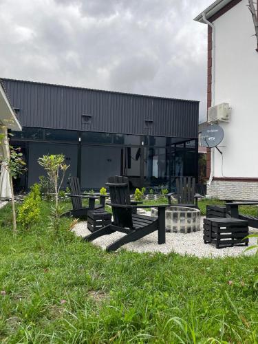 a patio with a table and chairs in front of a building at Qafqaz Milan Villa With Outdoor Heated Pool in Gabala
