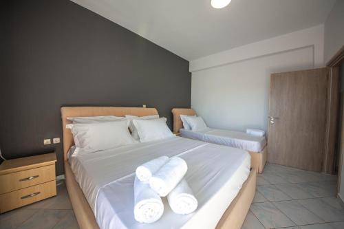 a bedroom with two white towels on a bed at Noemi's Hotel Ksamil in Ksamil