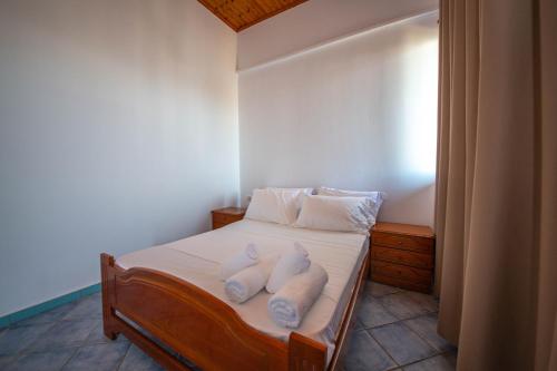 a bedroom with a bed with towels on it at Noemi's Hotel Ksamil in Ksamil