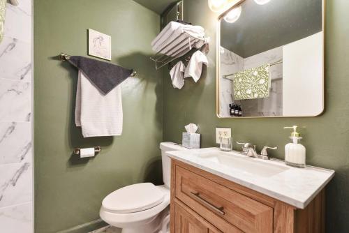 a bathroom with a sink and a toilet and a mirror at Lawrenceville Charm Free Park in Pittsburgh