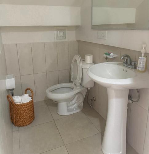 a bathroom with a toilet and a sink at Casa frente a la playa con vista al mar in Vacamonte