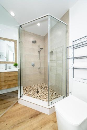 a shower with a glass enclosure in a bathroom at NoHo Home Near Universal Studios in Burbank