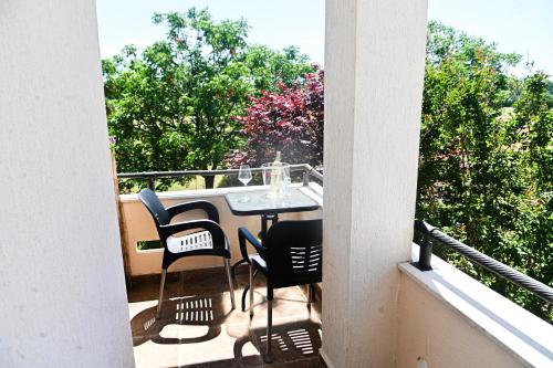a patio with a table and chairs on a balcony at Antonios Apartments in Ulcinj