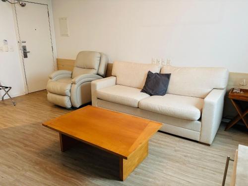 a living room with a couch and a coffee table at Morada Supreme Flat Jardim Europa II in Sao Paulo