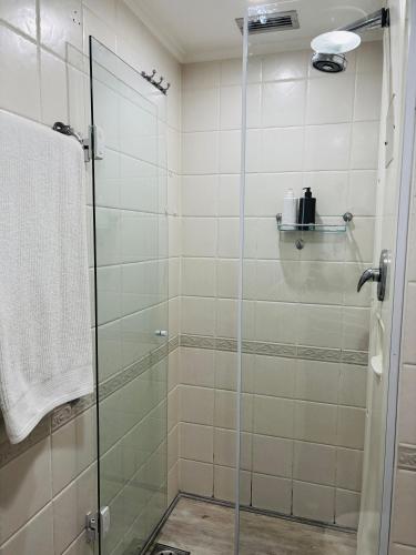 a shower with a glass door in a bathroom at Morada Supreme Flat Jardim Europa II in Sao Paulo