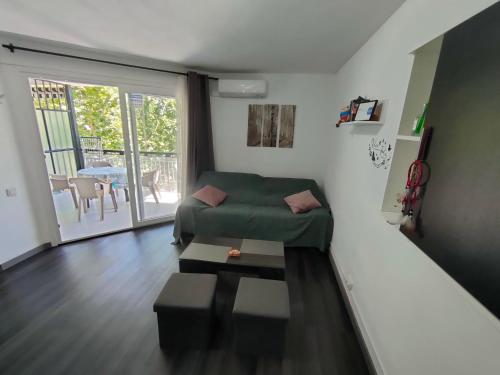 a living room with a green couch and a table at Lorena in Salou
