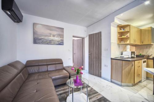 a living room with a couch and a table at Apartments Villa Excellente Belvedere in Pula