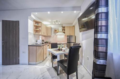a small kitchen with a table and a refrigerator at Apartments Villa Excellente Belvedere in Pula