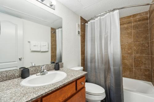 Un baño con lavabo, inodoro y ducha. en Reserve 1331 I Spacious 1 Bed 1 Bath, en Houston