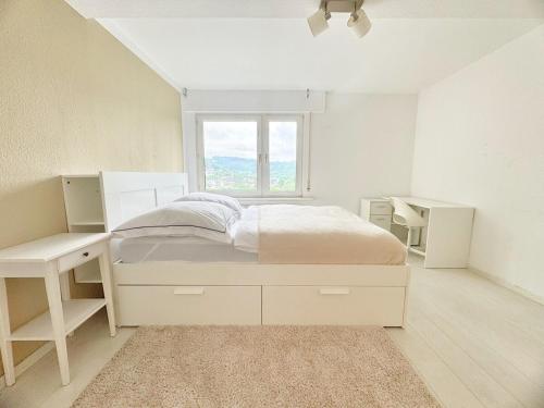 a white bedroom with a bed and a window at 95qm Komfort & Natur Pur in Werdohl