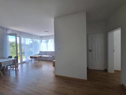 an empty living room with a bed and a table at Apartament Blisko Starego Miasta in Gdańsk