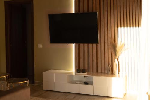 a living room with a tv on top of a white cabinet at Il Rifugio Verde 1 in Selcetta