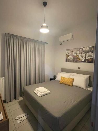 a bedroom with a large bed with a yellow pillow at Trifhouse - Village and Sea escape in Neochórion