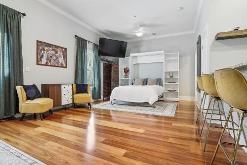 a bedroom with a bed and some yellow chairs at 1 bedroom home In Baton Rouge La in Baton Rouge