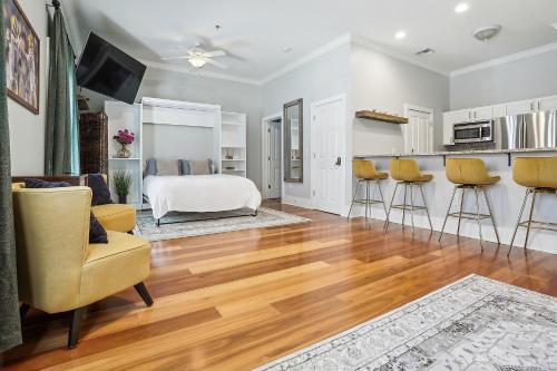 a living room with a bed and some chairs at 1 bedroom home In Baton Rouge La in Baton Rouge