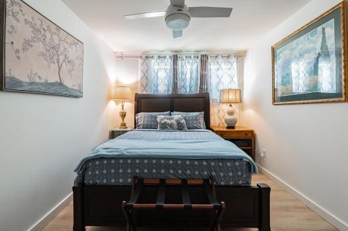 a bedroom with a bed and two lamps and two pictures at 1400sf Cozy Retreat with Sound View, Garden & Privacy in Federal Way
