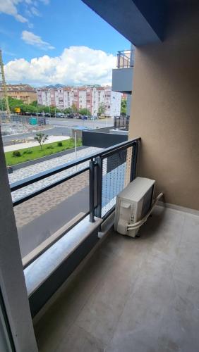 a balcony of a building with a computer on it at BrandNew Apartment in Podgorica
