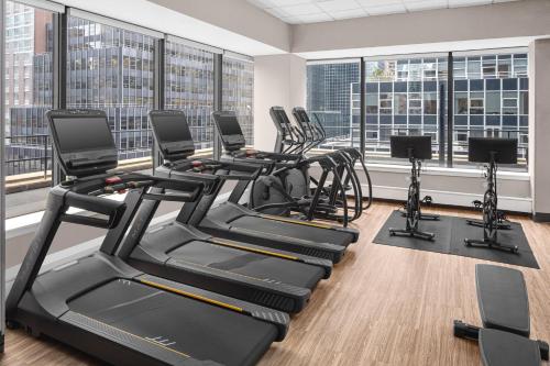 a gym with cardio equipment and large windows at Courtyard New York Manhattan/Midtown East in New York