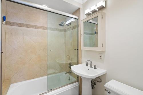 a bathroom with a sink and a shower at The Andalusite - Oceanfront Steps from the Sand in Los Angeles