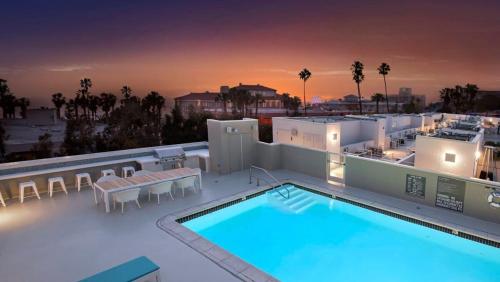 a swimming pool on the roof of a building at The Andalusite - Oceanfront Steps from the Sand in Los Angeles