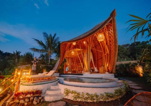 a resort with a large building with a pool at Angel Bali Suites in Selat