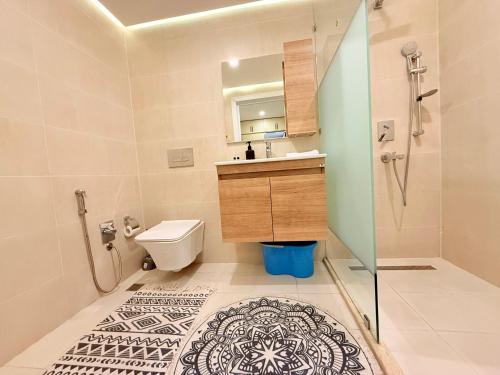 a bathroom with a toilet and a sink and a shower at Park Azure 0414 in Baku