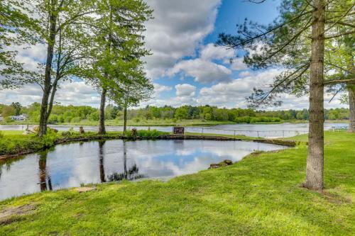 a pond in the middle of a field with trees at Hatfield Family Home on Lake Arbutus Boat and Hike in Neillsville