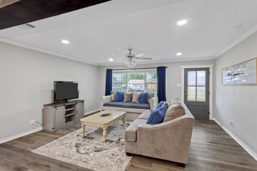 a living room with a couch and a tv at 3 Bedroom House in Lake Charles in Lake Charles
