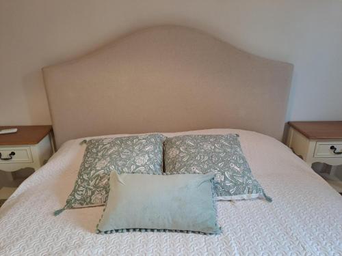 a bed with two pillows on it with two tables at Vistamare in Marina di Cecina
