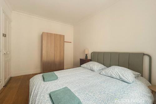 une chambre avec un grand lit avec une tête de lit verte dans l'établissement Jardin des Plantes - Beautiful bright 2-bedroom apartment -1 living room, à Paris