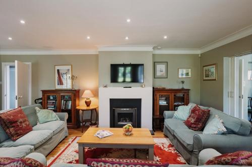 a living room with two couches and a fireplace at Little Orchard - Cowes in Isle of Wight