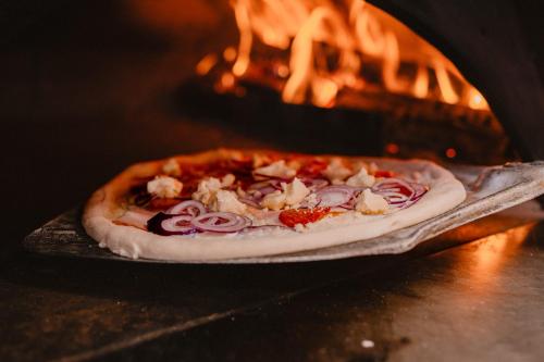 a pizza is being cooked in an oven at Hotel Lesana in Vysoké Tatry