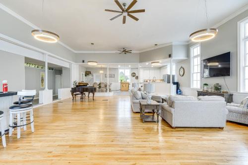 a large living room with white furniture and a kitchen at Unique Church Turned Family Retreat Relax and Enjoy in Alliance