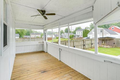 an empty porch with a ceiling fan and windows at Unique Church Turned Family Retreat Relax and Enjoy in Alliance