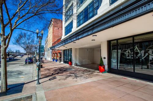 an empty city street with a building and a tree at Urban Retreat in Knoxville