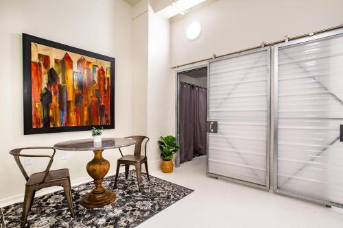 a dining room with a table and chairs and a painting at Urban Retreat in Knoxville