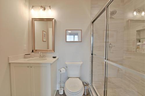 a bathroom with a toilet and a sink and a shower at Waterfront Retreat in Knoxville